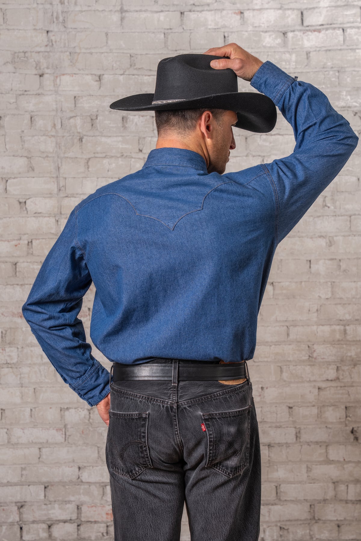 Men's Classic Stonewashed Denim Western Shirt by Rockmount Ranch Wear in vintage blue with sawtooth pockets and diamond snaps