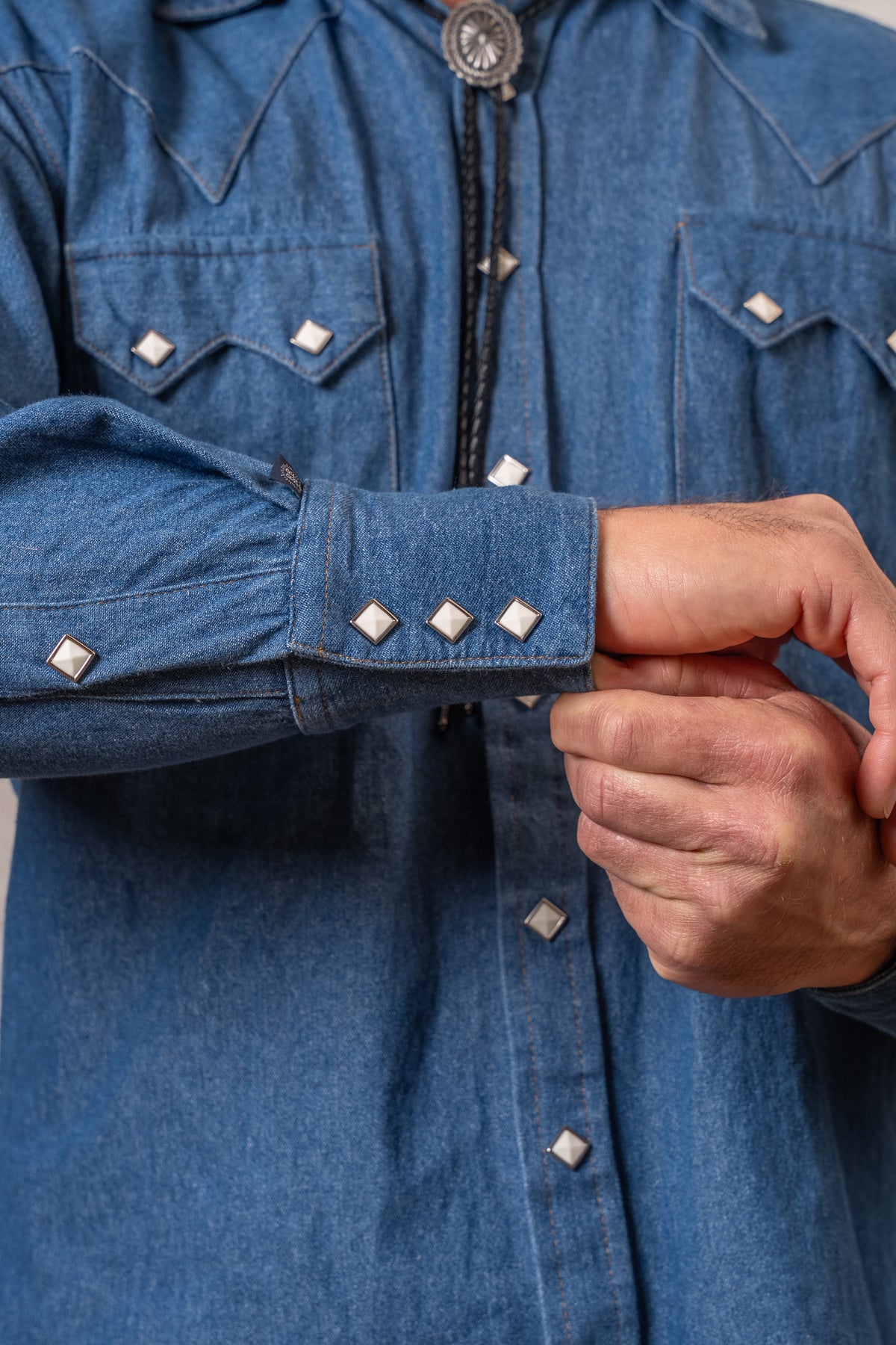 Men's Classic Light Blue Denim Western Shirt by Rockmount Ranch Wear with diamond snaps on the cuff