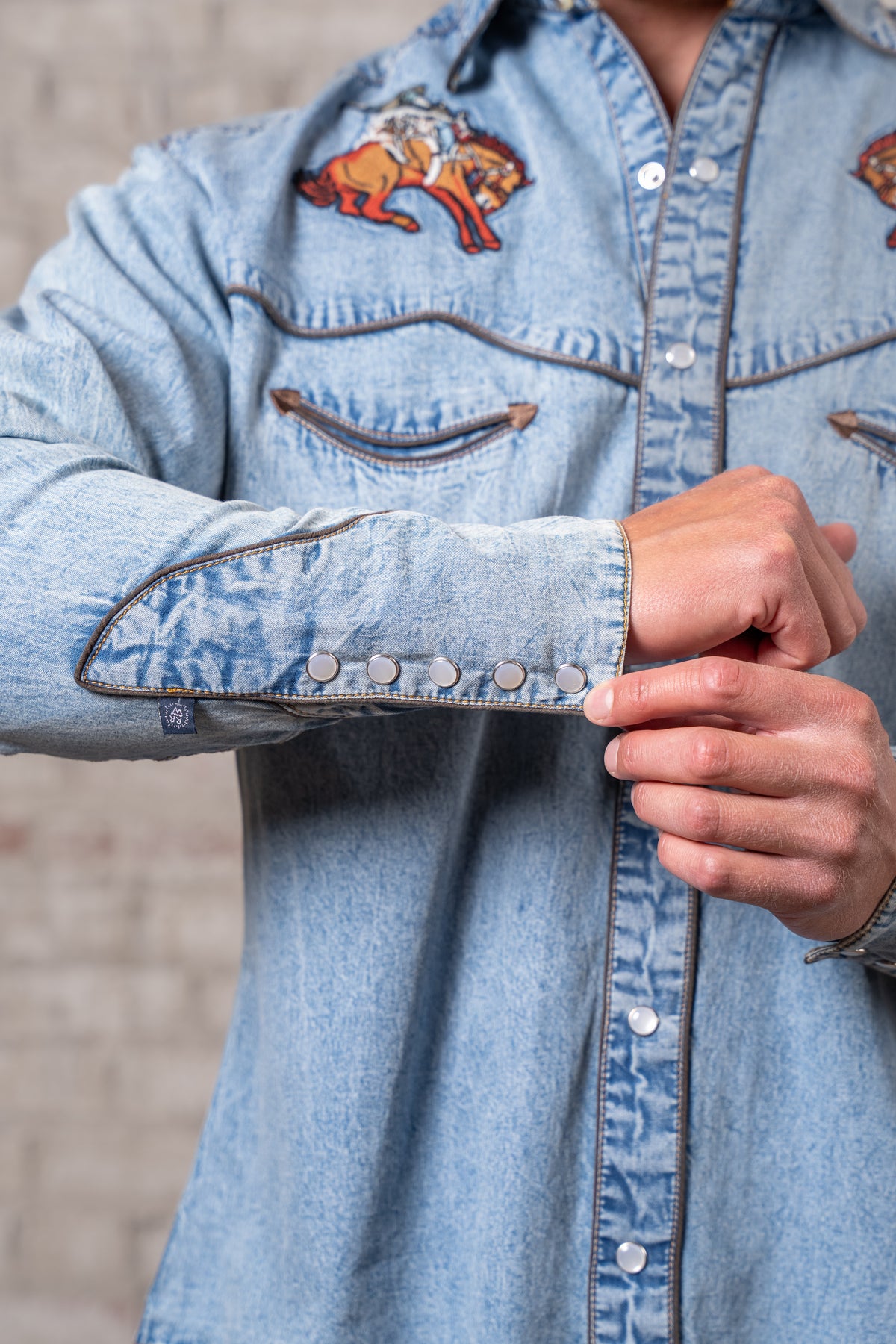 Men's Denim Iconic Bronc Embroidery Western Shirt by Rockmount Ranch Wear in vintage denim with snap button cuffs