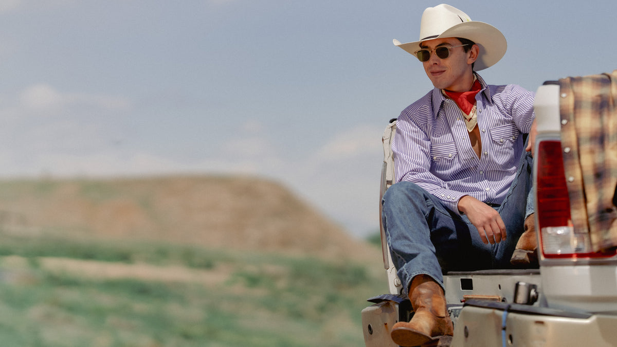 Vintage western shirt with striped pattern, worn by a cowboy in a pickup truck outdoors