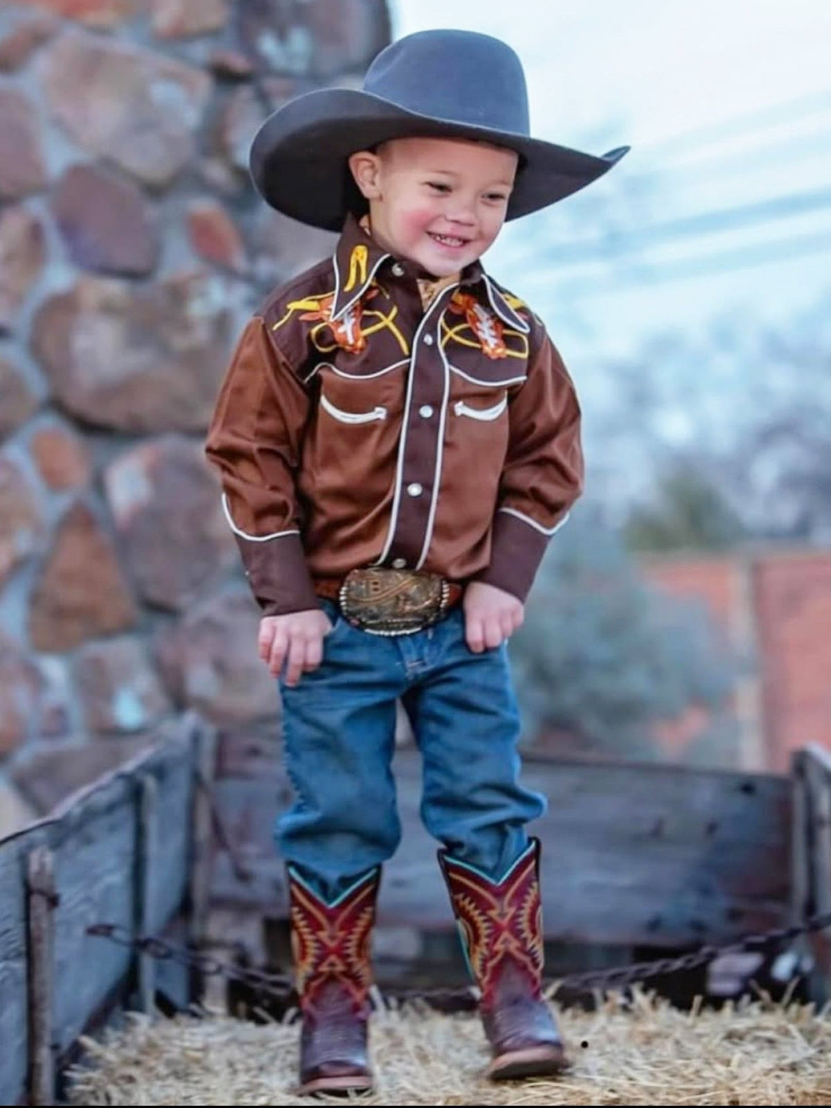 Vintage western shirt with embroidered floral fringe trim on a smiling child wearing a cowboy hat